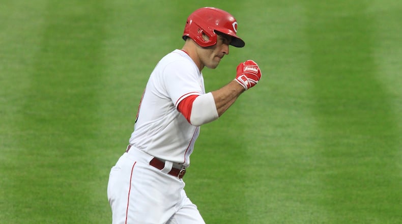 Joey Votto, of the Reds, celebrates after hitting a two-run home run against the Brewers on Wednesday, Sept. 23, 2020, at Great American Ball Park in Cincinnati. David Jablonski/Staff