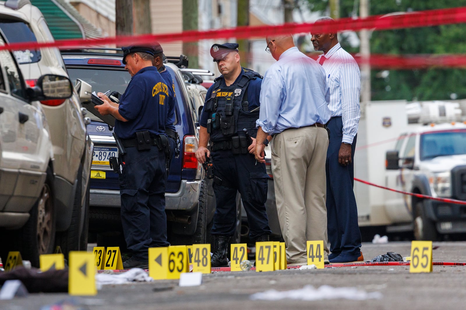 Crime Scene Unit officers and detectives work the scene of an overnight shooting in Philadelphia, early Monday, July 7, 2025. (Alejandro A. Alvarez/The Philadelphia Inquirer via AP)