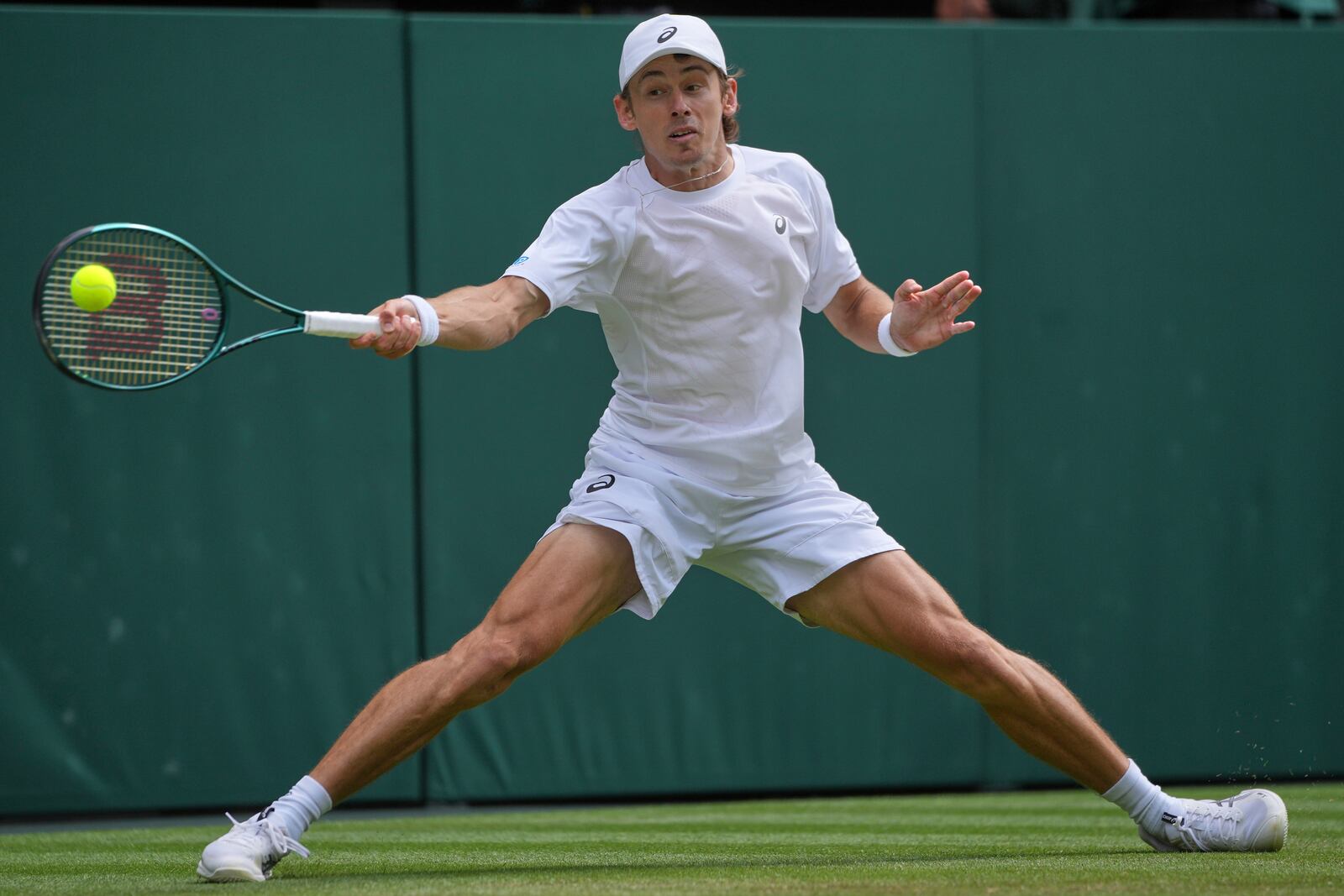 Australia's Alex de Minaur returns to Serbia's Novak Djokovic during a fourth round men's singles match at the Wimbledon Tennis Championships in London, Monday, July 7, 2025. (AP Photo/Kin Cheung)