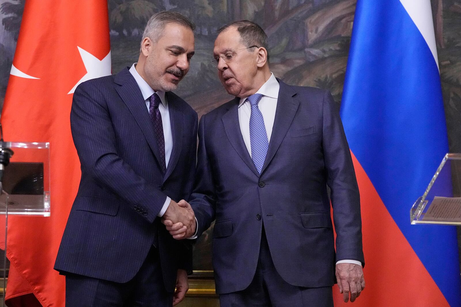Russian Foreign Minister Sergey Lavrov, right, and Turkish Foreign Minister Hakan Fidan shake hands during their meeting in Moscow, Russia, Tuesday, May 27, 2025. (AP Photo/Pavel Bednyakov, Pool)