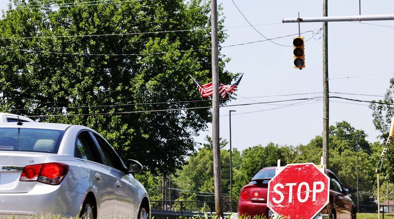 Temporary stop signs were up at some intersections, like this one at Verity Parkway and 14th Ave., as signal lights were out due to power outages. Many were still without power Tuesday, June 14 in Middletown after storms damaged trees and knocked down power lines. NICK GRAHAM/STAFF