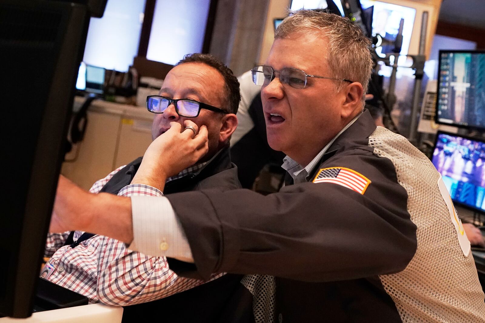 Traders Bryan Masseria, left and Columb Lytle work on the floor of the New York Stock Exchange, Thursday, April 10, 2025. (AP Photo/Richard Drew)
