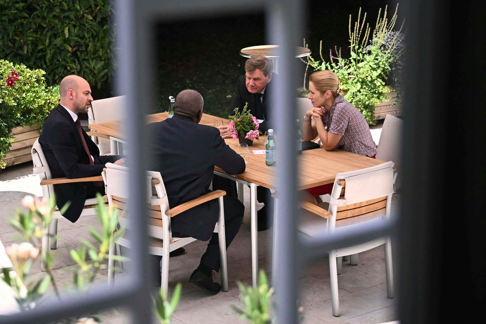 France's Minister for Europe and Foreign Affairs Jean-Noel Barrot, from left, Britain's Foreign Secretary David Lammy, Germany's Foreign Minister Johann Wadephul and European Union High Representative for Foreign Affairs and Security Policy, Kaja Kallas, meet at an outdoor terrace table at the offices of the honorary Consul of the Federal Republic of Germany in Geneva, Friday, June 20, 2025. (Fabrice Coffrini/Keystone via AP)
