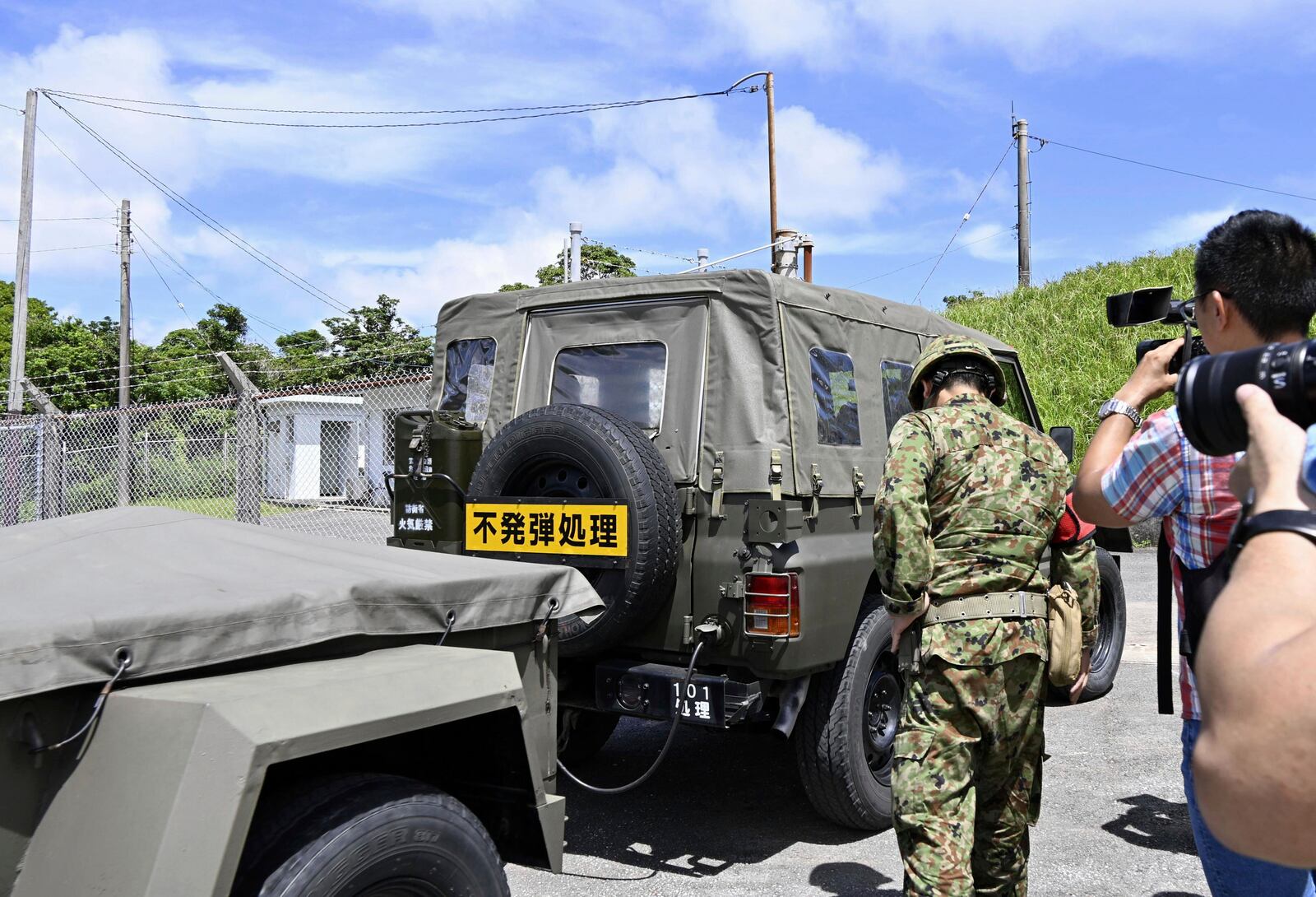 A Japan Self-Defence Forces vehicle enters an area of ammunition store in the town of Yomitanson, Okinawa prefecture, southern Japan Monday, June 9, 2025. A yellow sign reads "Bomb Disposal." (Kyodo News via AP)