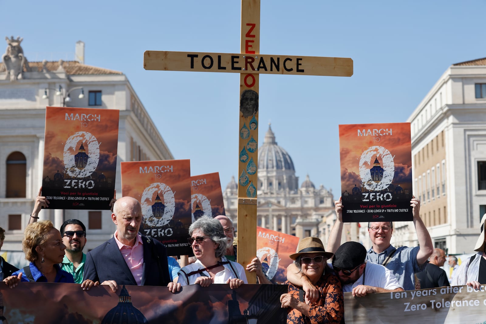FILE - From left, survivor-activists psychoneurologist Denise Buchanan, psychotherapist Peter Isely, Kazlaw Injury & Trauma Lawyers' support team specialist Leona Huggins and president of Ending Clergy Abuse Timothy Law hold a wooden cross as they arrive at the Vatican, Sept. 27, 2023, at the end of their pilgrimage to protest the pope's failure to end clergy abuse. (AP Photo/Riccardo De Luca, File)