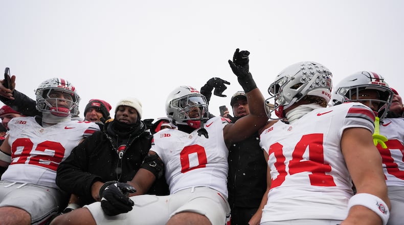 Ohio State Buckeyes defensive end Caden Curry, linebacker Sonny Styles, and wide receiver Brennen Schramm, from left, celebrate after the team's win against Michigan in an NCAA college football game, Saturday, Nov. 29, 2025, in Ann Arbor, Mich. (AP Photo/Ryan Sun)