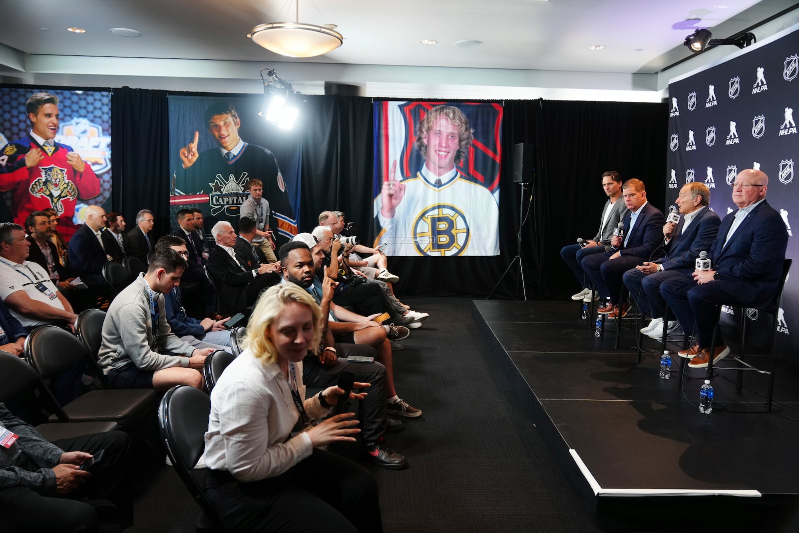 On stage from left to right, Ron Hainsey, NHLPA Assistant Executive Director; Marty Walsh, NHLPA Executive Director; Gary Bettman, NHL Commissioner, and Bill Daly, NHL Deputy Commissioner, conduct a joint press conference before the NHL hockey draft Friday, June 27, 2025, in Los Angeles. (AP Photo/Damian Dovarganes)