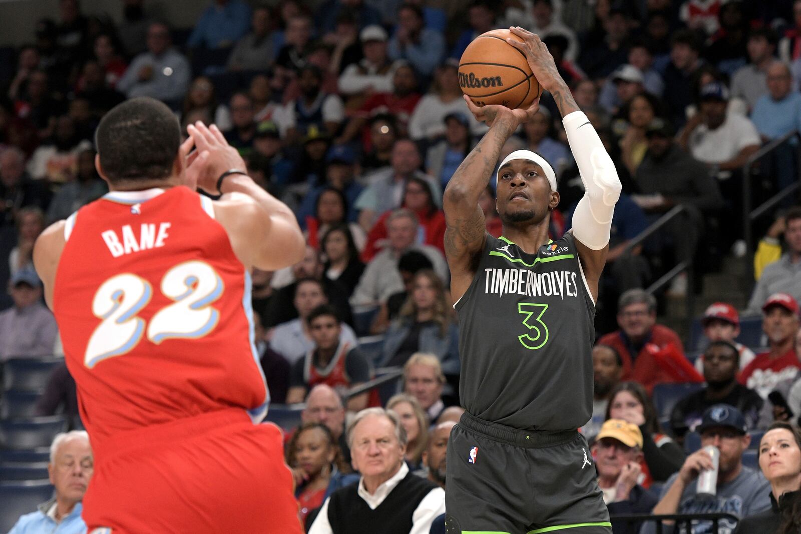 Minnesota Timberwolves forward Jaden McDaniels (3) shoots against Memphis Grizzlies guard Desmond Bane (22) in the first half of an NBA basketball game Thursday, April 10, 2025, in Memphis, Tenn. (AP Photo/Brandon Dill)