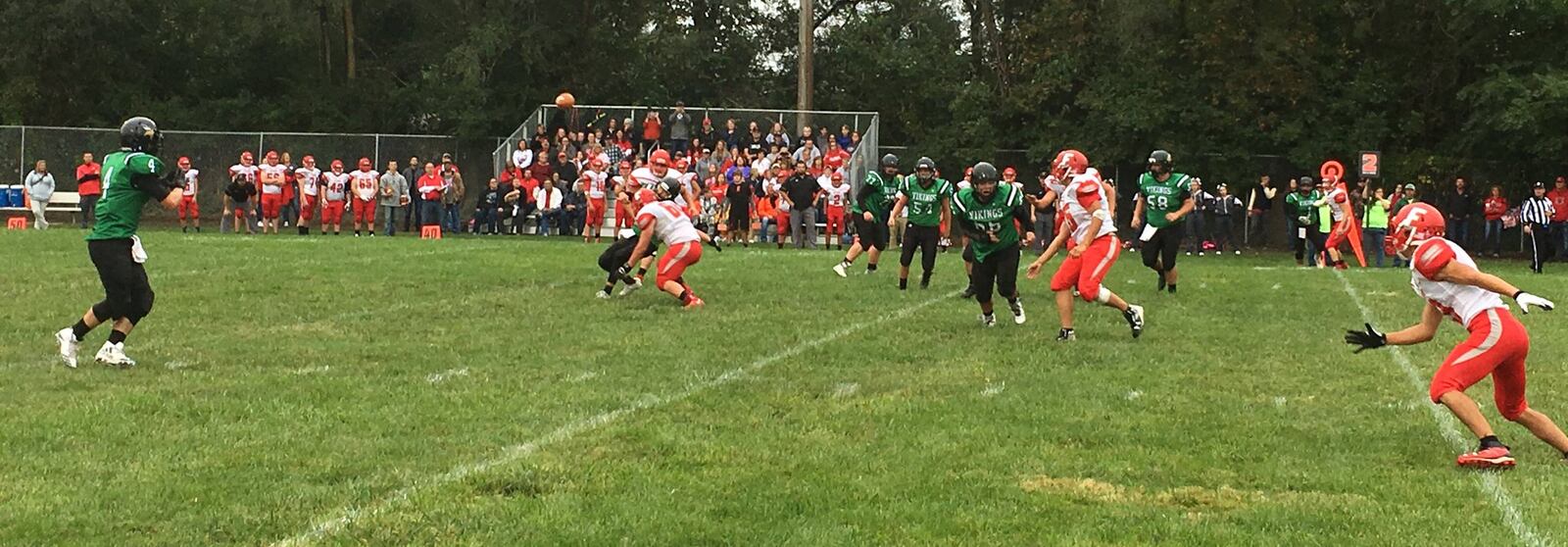 New Miami’s Brody Honaker (4) is about to catch a swing pass from quarterback Trey Robinette during Saturday night’s game against Marion Elgin at Mara Field in New Miami. RICK CASSANO/STAFF