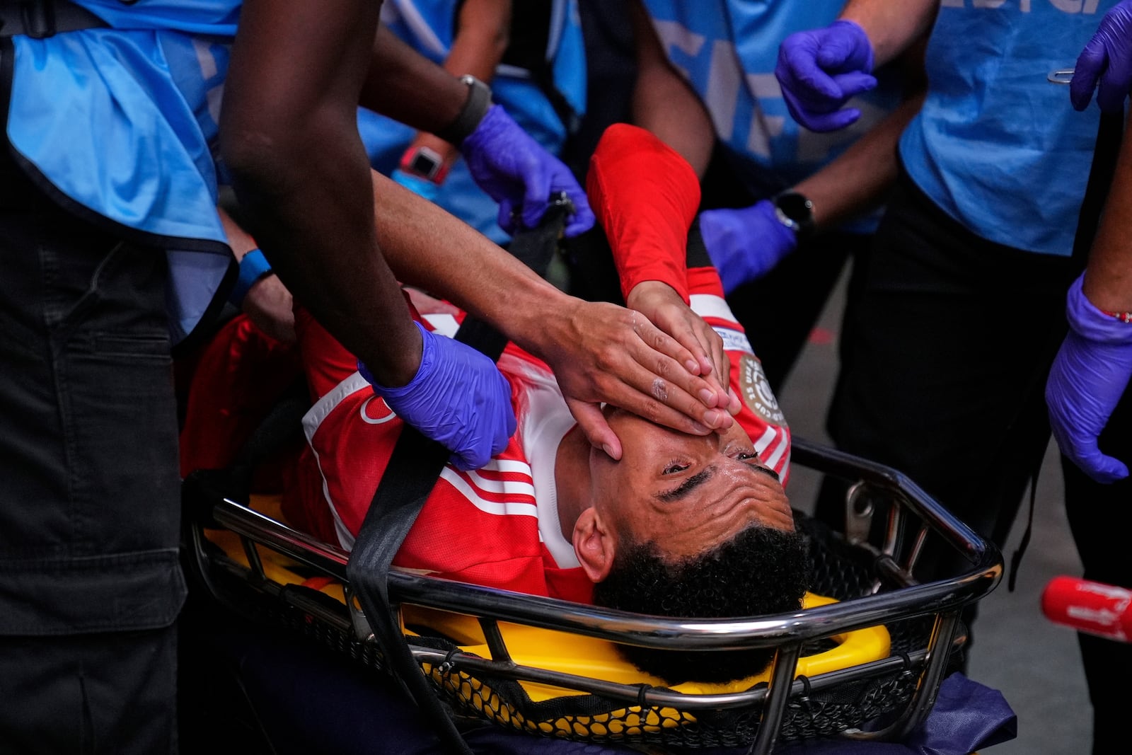 Bayern Munich's Jamal Musiala is taken off the field after an injury during the Club World Cup quarterfinal soccer match between PSG and Bayern Munich in Atlanta, Saturday, July 5, 2025. (AP Photo/Brynn Anderson)