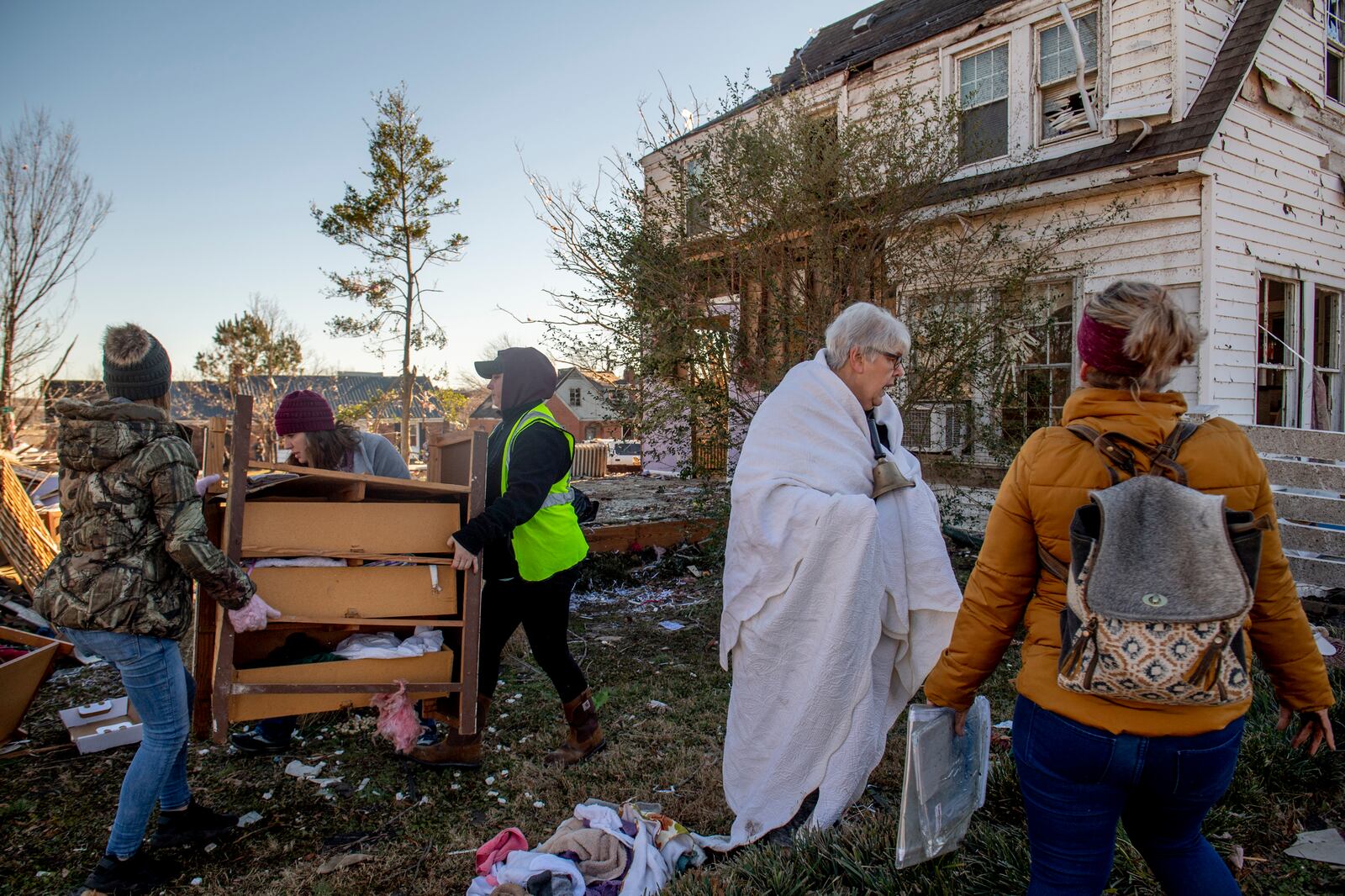 Volunteers help Martha Thomas, second from right, sort debris from her home in Mayfield, Ky. on Monday, Dec. 13, 2021, after a tornado swept across the region. Determining how many people died in the tornadoes that ravaged the central U.S. on Friday has been a challenging task so far, with estimates fluctuating as search teams continue to spread out amid vast fields of rubble in an effort to rescue the living and account for the dead. (Johnny Milano/The New York Times)