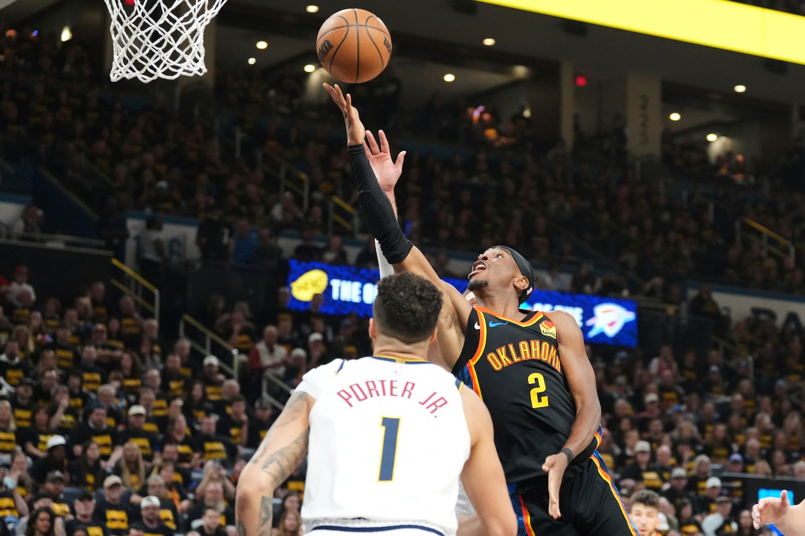 Oklahoma City Thunder guard Shai Gilgeous-Alexander (2) takes a shot as Denver Nuggets' Michael Porter Jr. (1) defends in the second half of Game 2 in the conference semifinals of the NBA basketball playoffs, Wednesday, May 7, 2025, in Oklahoma City. (AP Photo/Kyle Phillips)