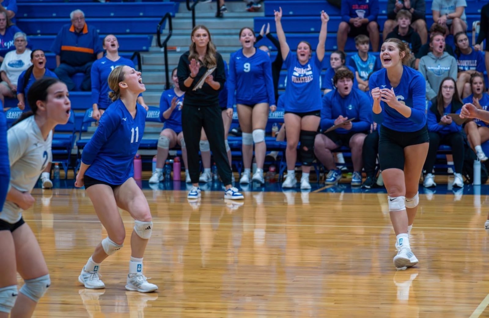 Brookville High School senior Sidney Sprada, senior Logyn Barr (11) and senior Paloma Carey (2) celebrate during a recent match for the Blue Devils. CONTRIBUTED PHOTO