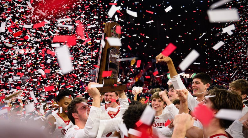 The Miami University men's basketball team hoists the Mid-American Conference trophy after beating Toledo 74-72 on Tuesday, March 3, 2026 at Millett Hall. JEREMY MILLER / CONTRIBUTED PHOTO