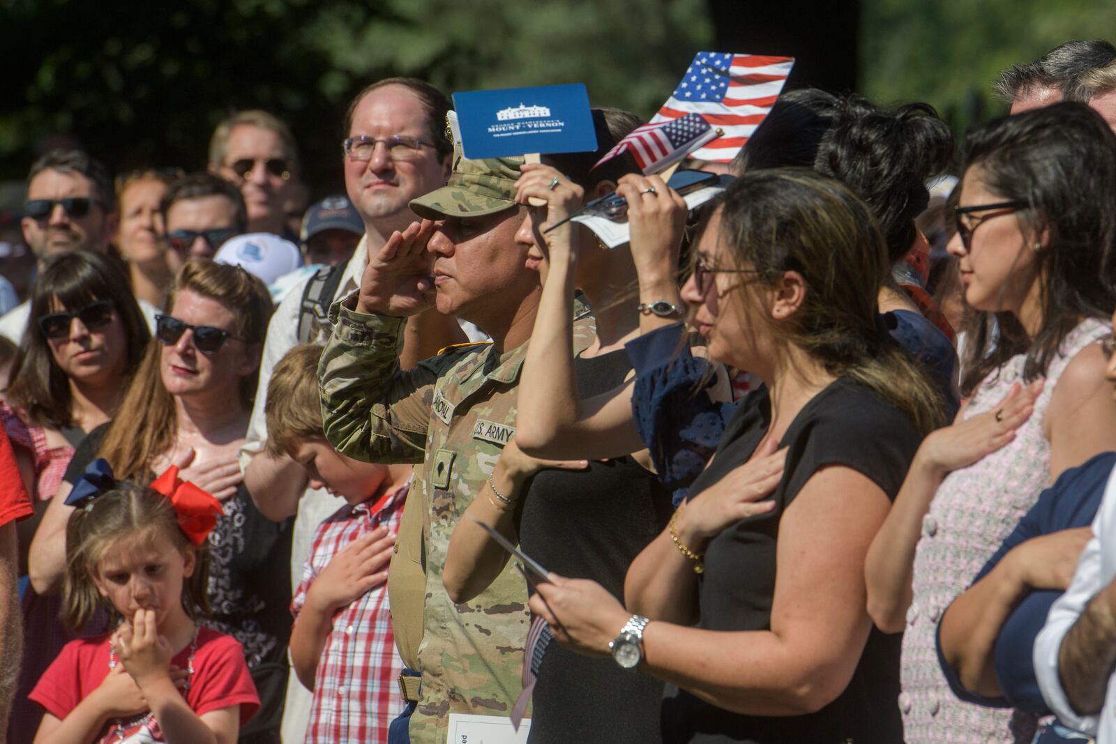 People stand for the National Anthem during their Naturalization Ceremony on Independence Day at George Washington's Mount Vernon, Friday, July 4, 2025, in Alexandria, Va. (AP Photo/Rod Lamkey, Jr.)