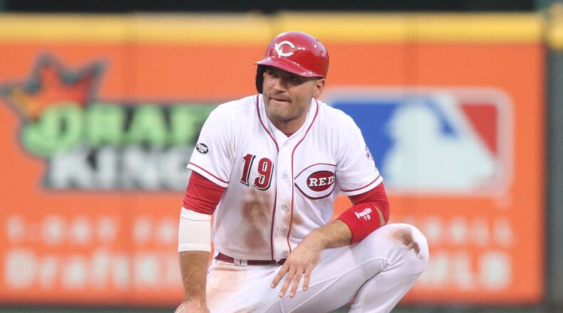 Joey Votto pauses after sliding into second base Tuesday. David Jablonski/Staff