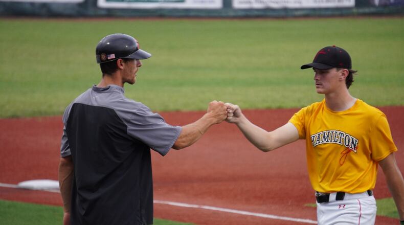 Hamilton Joes manager Tyler Thamann congratulates starting pitcher Cooper Fiehrer during a game against the Xenia Scouts on Thursday, July 4 at Foundation Field. Chris Vogt/CONTRIBUTED