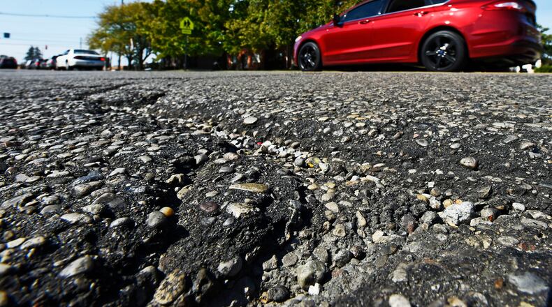 Cracks in the surface of NW Washington Boulevard near Eaton Avenue in Hamilton. NICK GRAHAM/STAFF