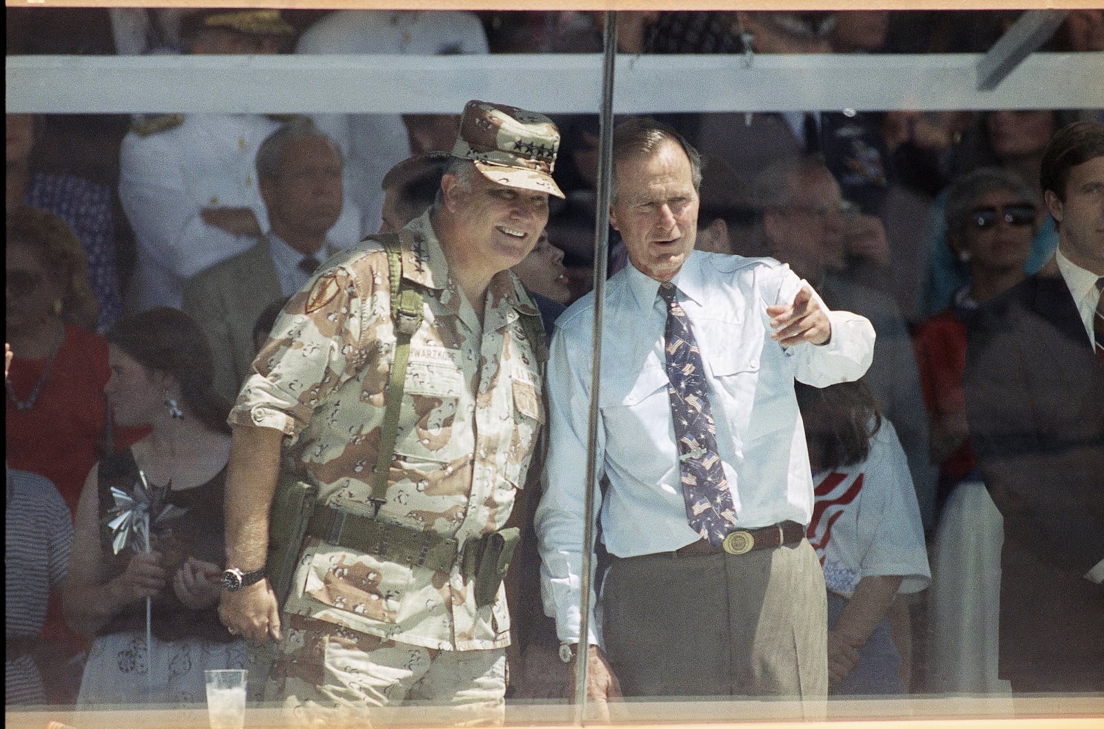 FILE - Gen. Norman Schwarzkopf, left, and President George HW Bush watch the National Victory Parade in Washington, June 8, 1991, after Schwarzkopf led his troops in the parade, and then joined Bush in the reviewing stand. (AP Photo/Ron Edmonds, File)