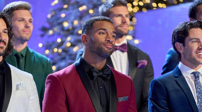 Men competing on "Finding Mr. Christmas" Season 2 team up to launch gifts into Santa’s sleigh, then soar sky-high as reindeer in an Entertainment Weekly photo shoot, where the winning team’s advantage shakes up the competition. HALLMARK/CONTRIBUTED