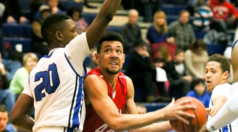 Fairfield forward Ben Phillips (42) looks to get a shot off against Hamilton’s Myles Howard (20) on Feb. 9 at the Hamilton Athletic Center. GREG LYNCH/STAFF