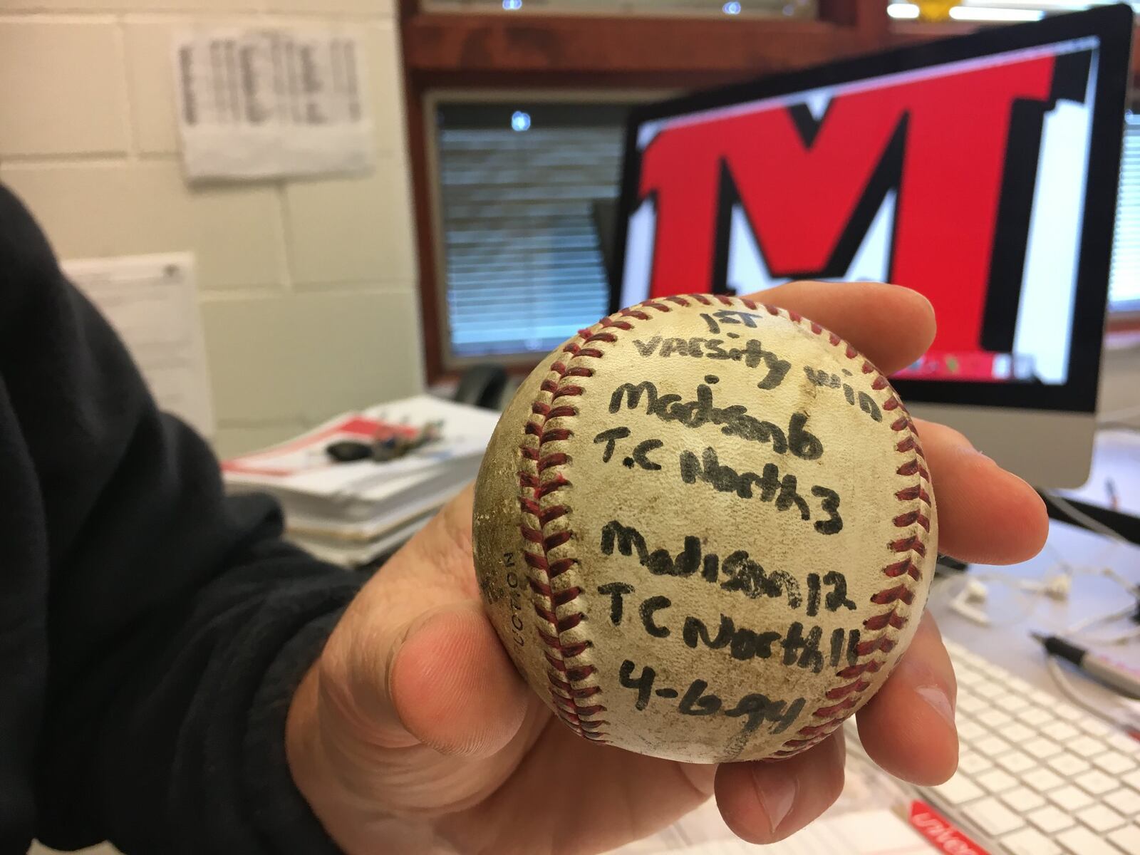 Bob Evick shows off the game ball from his first varsity win, a 6-3 decision over Tri-County North, as Madison High School’s head baseball coach in 1994. RICK CASSANO/STAFF