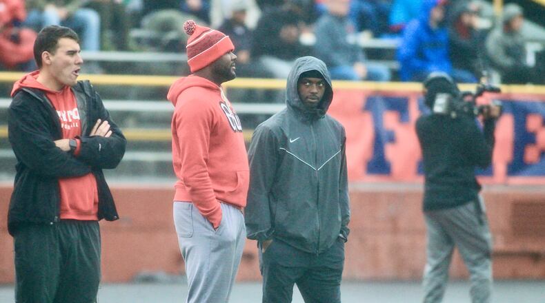 Former Ohio State quarterbacks Cardale Jones, left center, and J.T. Barrett, right center, watch as Dayton plays Butler on Saturday, Oct. 30, 2021, at Welcome Stadium. Jones knows Dayton wide receivers coach Jordan Overton, whose dad Tony coached Jones in high school. David Jablonski/Staff