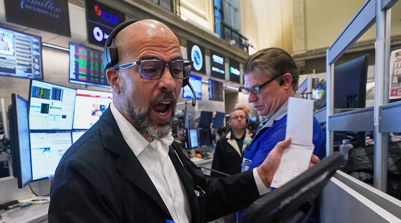 Options trader Steven Rodriguez, left, works on the floor of the New York Stock Exchange, Monday, Nov. 24, 2025. (AP Photo/Richard Drew)