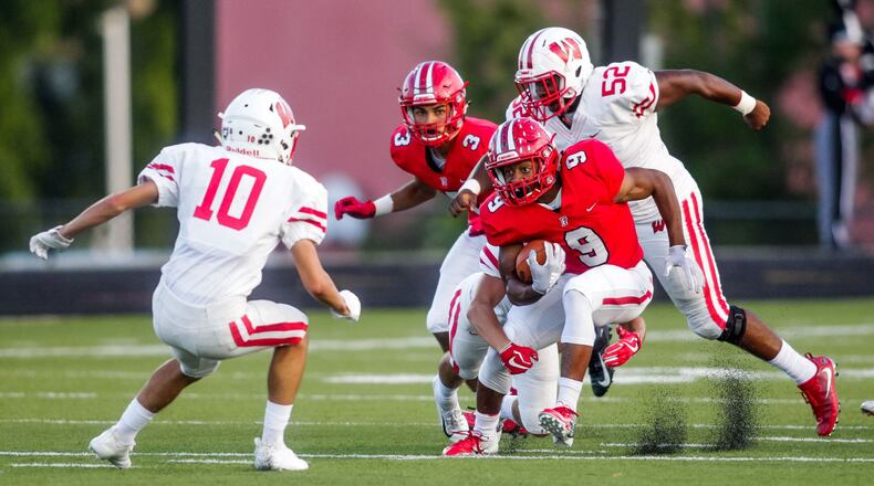 Fairfield’s JuTahn McClain cuts between Lakota West defenders Silas Walters (10) and Ladonnis Griffin (52) during Friday night’s game at Fairfield Stadium. McCain rushed for 140 yards and three touchdowns in the Indians’ 37-3 win. NICK GRAHAM/STAFF
