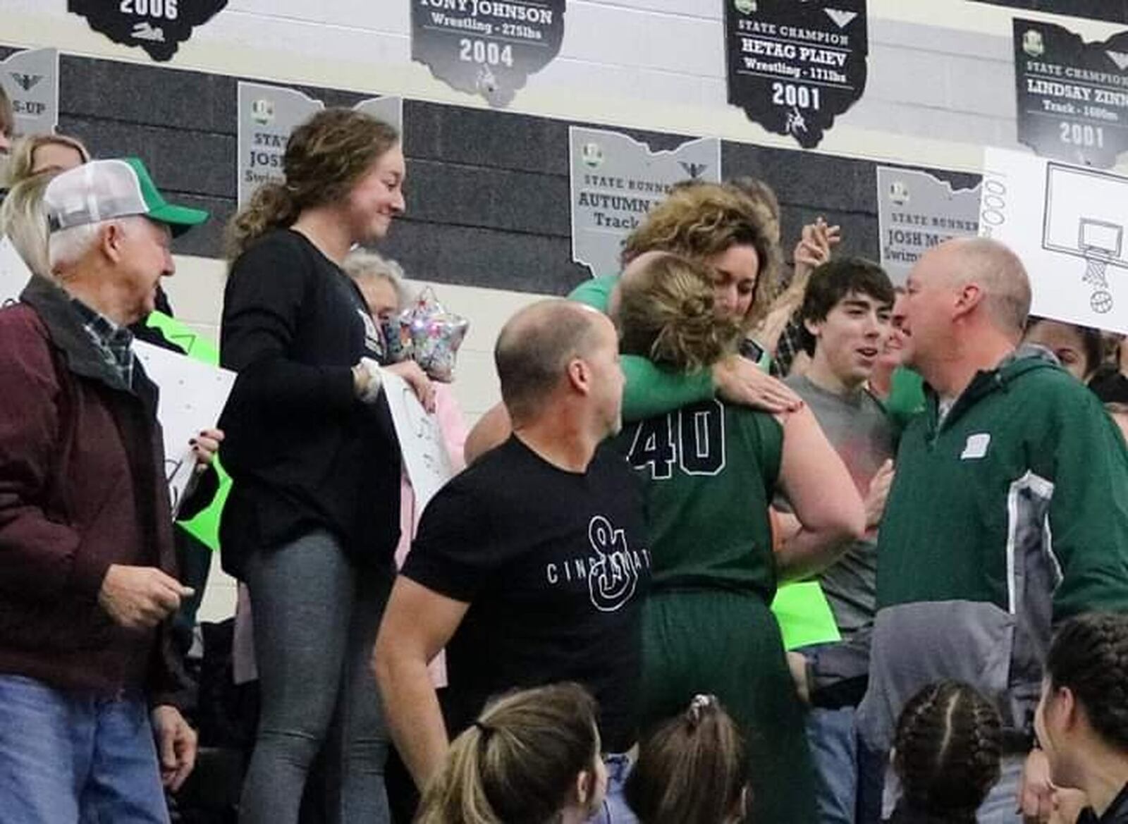 Badin senior forward Emma Broermann hugs her mother Deanna after scoring her 1,000th career point in the second quarter of Thursday night’s game at Lakota East. Her father Nick is on the right. CONTRIBUTED PHOTO BY TERRI ADAMS
