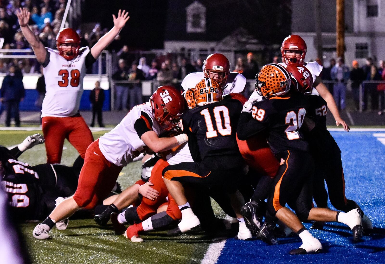 Madison’s Max Evans (38) signals touchdown as quarterback Mason Whiteman fights through the pile for a score during Friday night’s Division V state semifinal against Wheelersburg at Herrnstein Field in Chillicothe. NICK GRAHAM/STAFF