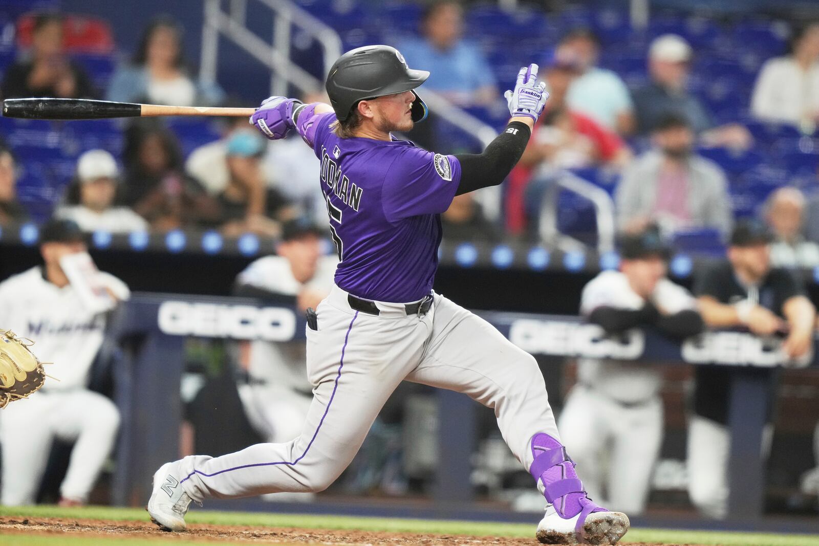 Colorado Rockies' Hunter Goodman follows through on a solo home run during the eighth inning of a baseball game against the Miami Marlins, Tuesday, June 3, 2025, in Miami. (AP Photo/Lynne Sladky)