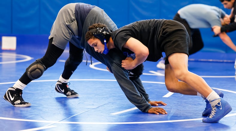 Hamilton High School senior wrestler Jayden Knowles practices with teammate Rante Wagner on the mat. Knowles recently earned the 100th win of his wrestling career. NICK GRAHAM/ STAFF