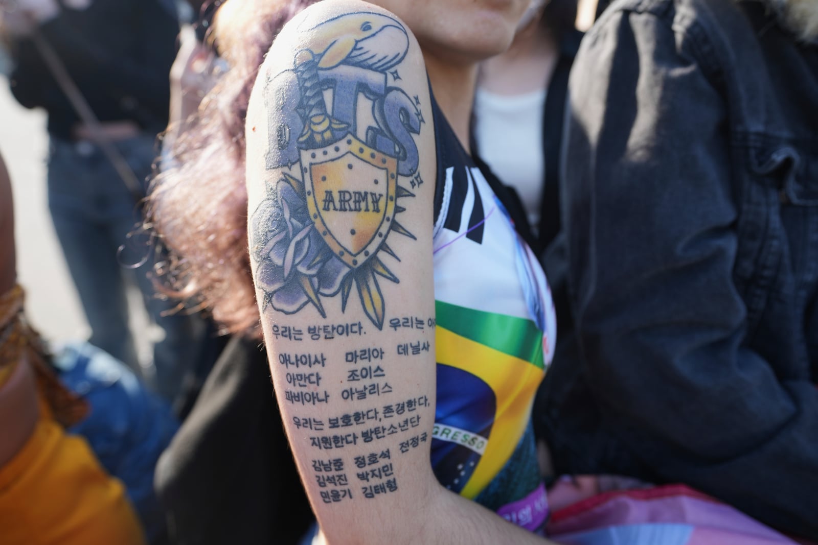 Anaisa Silva, from Portugal, a fan of K-pop band BTS shows a tattoo as they wait for K-pop band BTS members Jimin and Jung Kook in Yeoncheon, South Korea, Wednesday, June 11, 2025. (AP Photo/Lee Jin-man)