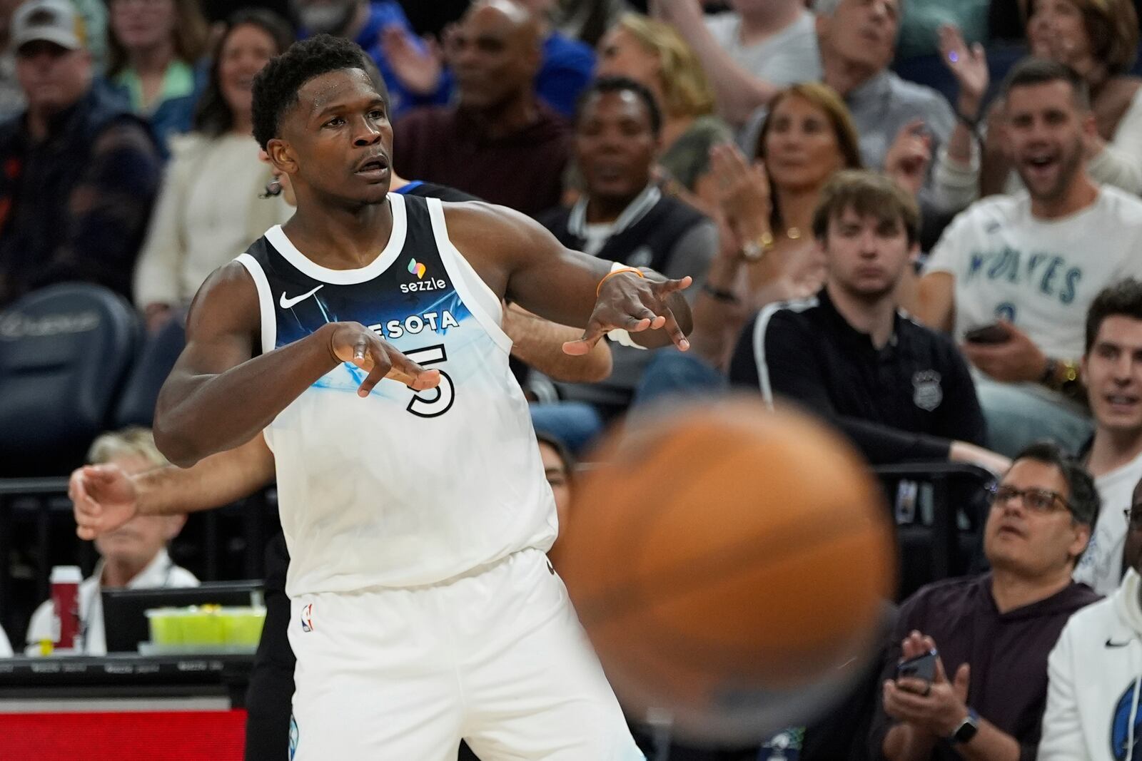 Minnesota Timberwolves guard Anthony Edwards (5) gestures after making a 3-point basket during the first half of an NBA basketball game against the Brooklyn Nets, Friday, April 11, 2025, in Minneapolis. (AP Photo/Abbie Parr)