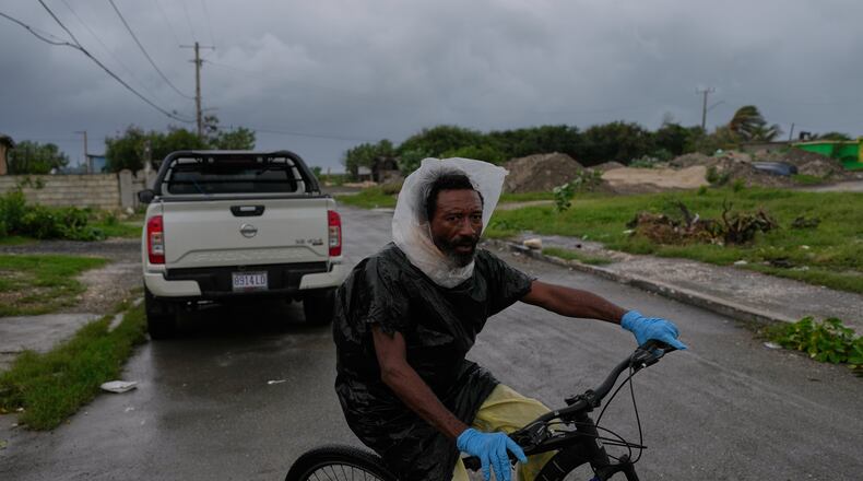 A man rides a bicycle ahead of the forecast arrival of Hurricane Melissa in Kingston, Jamaica, Sunday, Oct. 26, 2025. (AP Photo/Matias Delacroix)