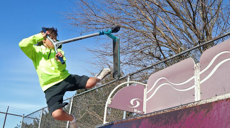 The 35 degree temperature didn't seem to bother Brayden Wiley, 13, as he practiced tricks on his scooter Monday morning at the New Carlisle skate park. The weather is supposed to stay cool all week with rain possible on Thanksgiving day. BILL LACKEY/STAFF