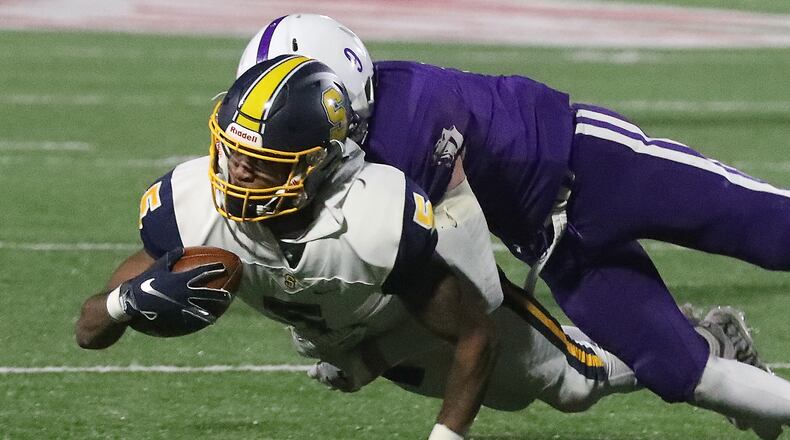 Larry Stephens of Springfield (with ball) is first team All-Ohio Division I. BILL LACKEY/STAFF