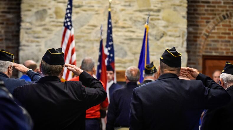 Veterans stand at attention during the singing of the national anthem at the annual Butler County Veterans Day program this year in Hamilton.