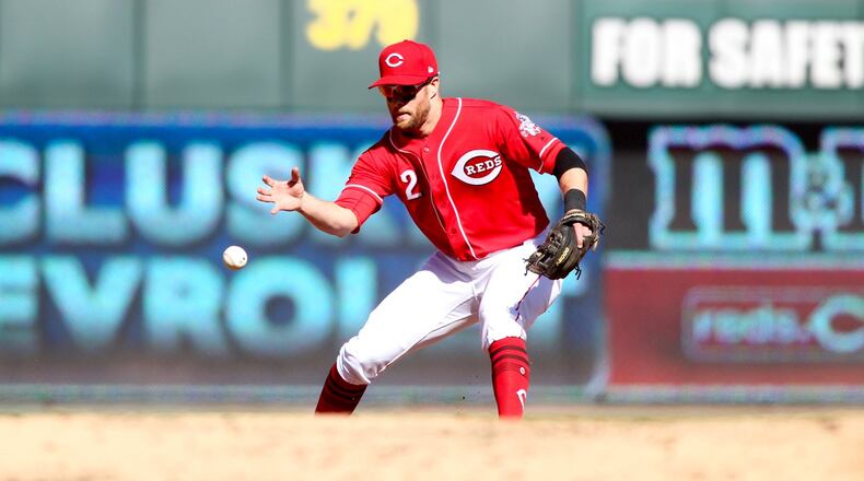 Reds shortstop Zack Cozart fields a ball with his bare hand against the Giants on Sunday, May 7, 2017, at Great American Ball Park in Cincinnati. David Jablonski/Staff