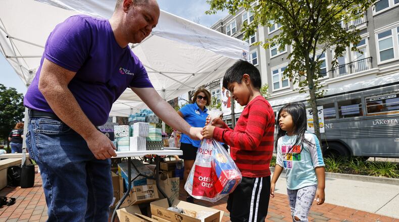 Last year saw a large turnout for the annual "Stuff The Bus" donation campaign at Liberty Center and Lakota and Cincinnati Children's officials hope for even more help this month with the campaign to get school supplies to the children of needy families. NICK GRAHAM/FILE PHOTO