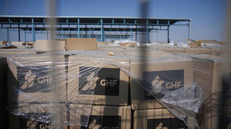 FILE - Piles of humanitarian aid packages from GHFwas, Gaza Humanitarian Foundation, wait to be picked up on the Palestinian side of the Kerem Shalom crossing in the Gaza Strip, Thursday, July 24, 2025. during a media tour organized by the Israeli army. (AP Photo/Ohad Zwigenberg, file)