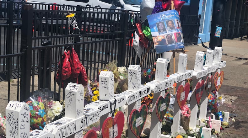 The memorial to the nine people killed in the Aug. 4 shooting in the Oregon District. Three victims had their birthdays in September. CORNELIUS FROLIK / STAFF