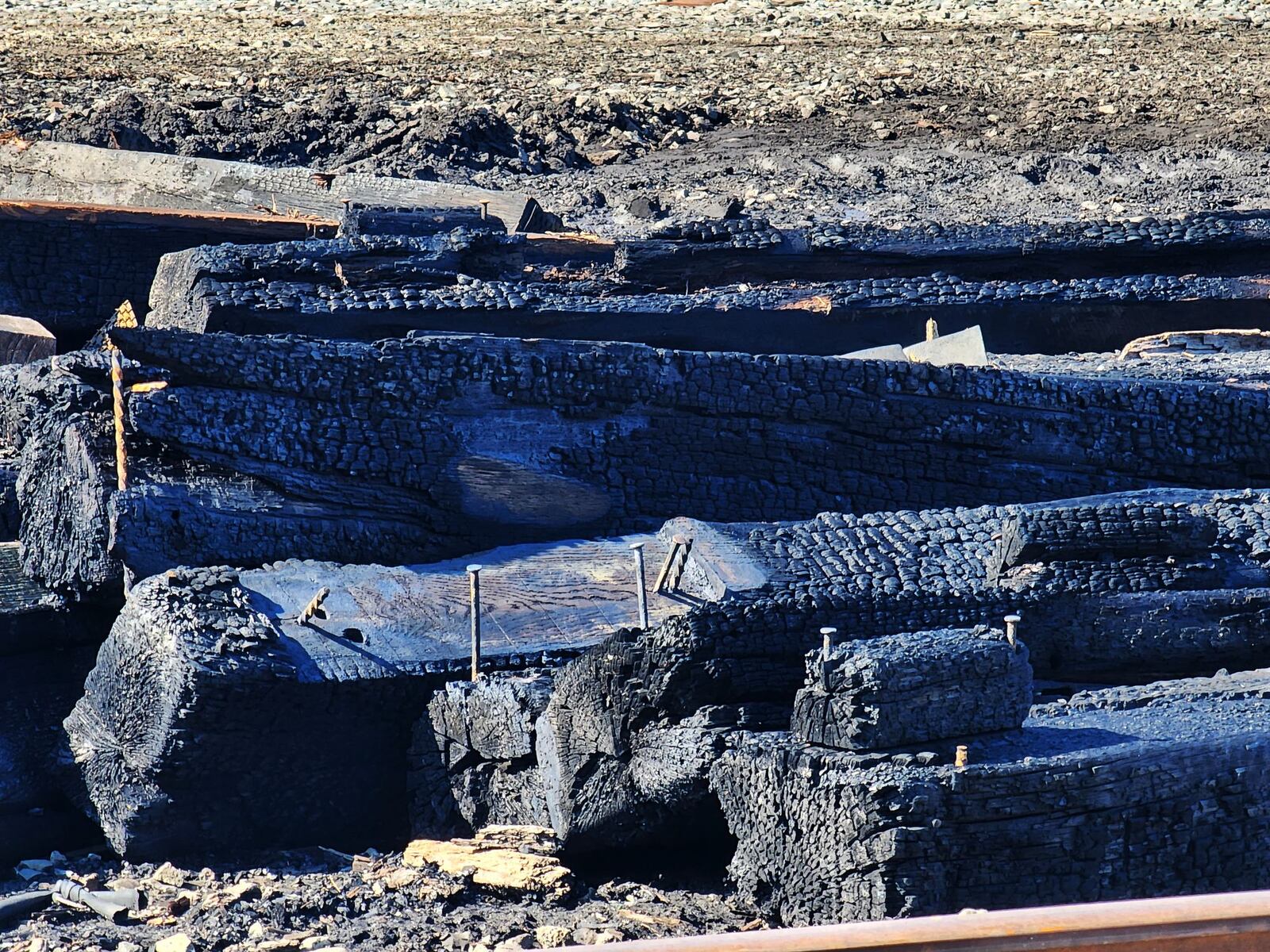 Charred remains of railroad ties were visible Monday in Middletown after the ties caught fire Sunday afternoon. The cause of the fire remains under investigation, according to Assistant Fire Chief Steve Ludwig. NICK GRAHAM/STAFF