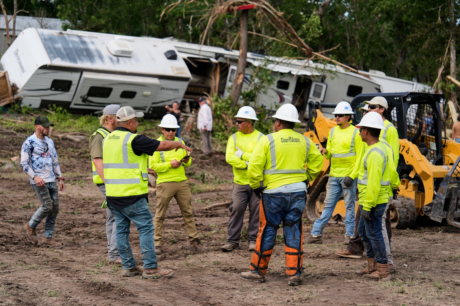 People help during clean-up efforts at Guadalupe Keys Resort, an RV park in Center Point, Texas, after flooding, Monday, July 7, 2025. (AP Photo/Ashley Landis)