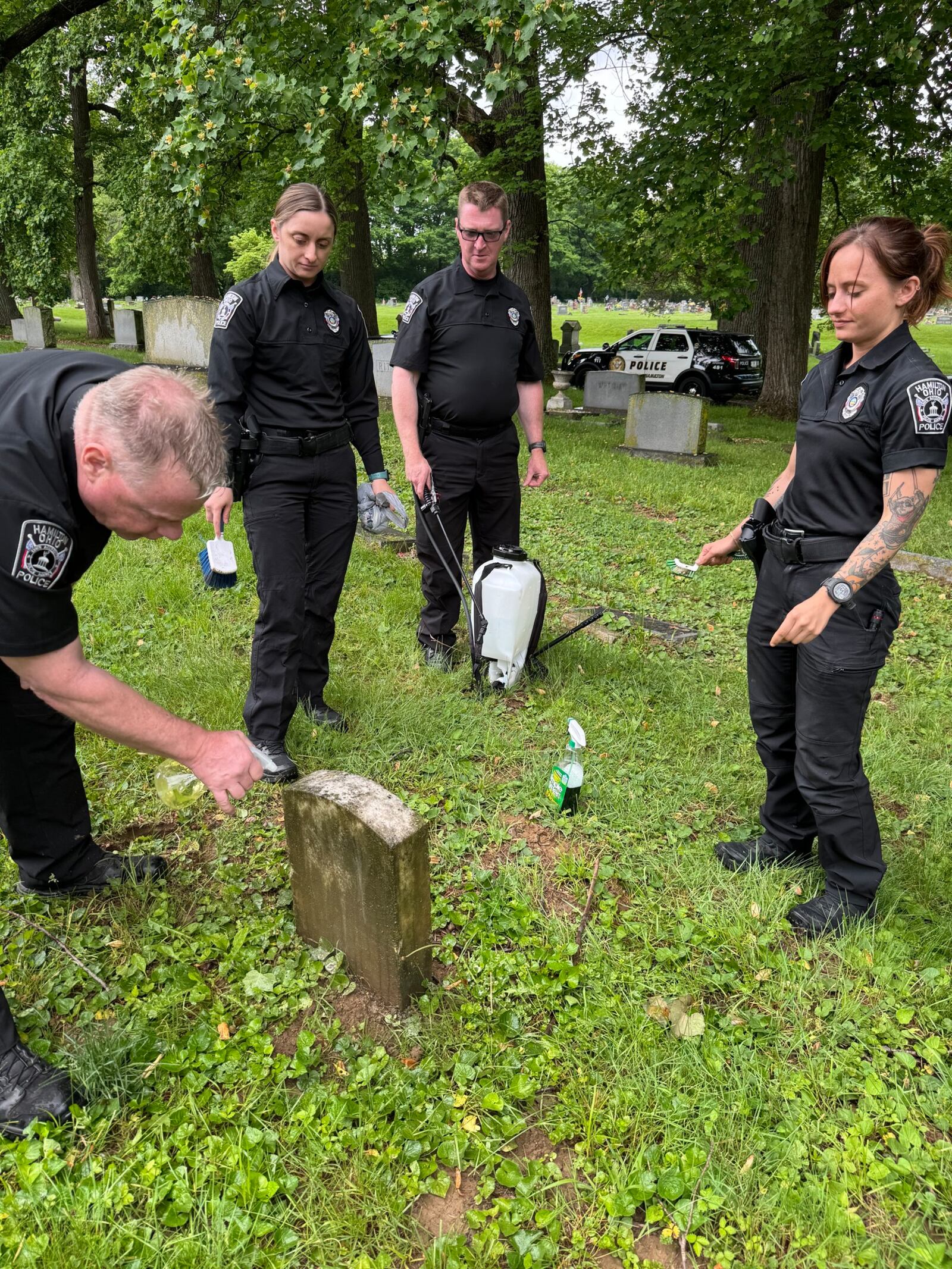 Hamilton officers cleaned the graves of fallen officers as part of National Police Week. SUBMITTED