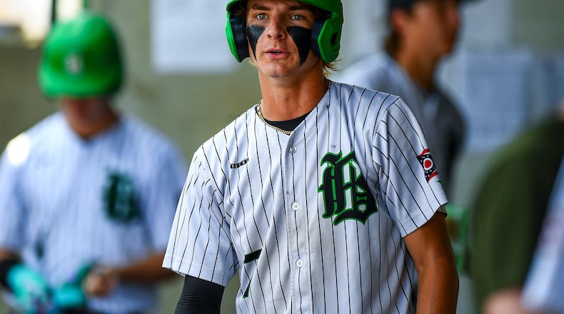 Badin senior Cooper Ollis walks into the dugout after scoring a run during a recent tournament game. KYLE HENDRIX / CONTRIBUTED