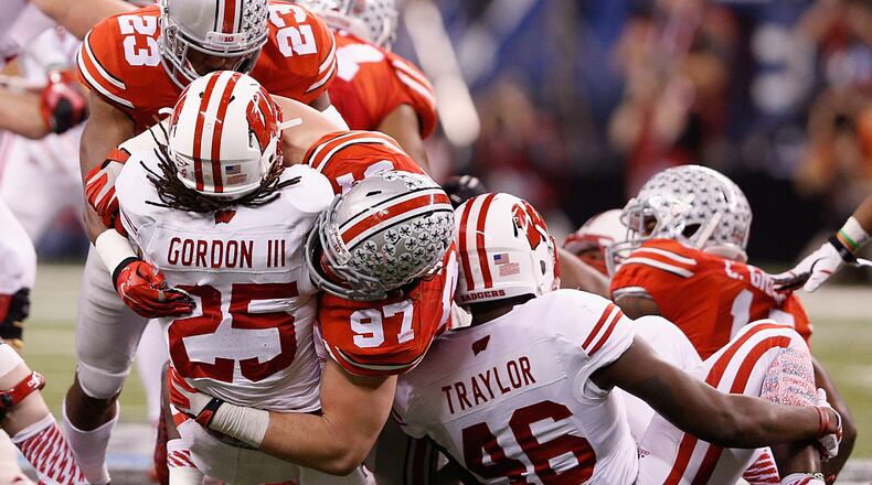 INDIANAPOLIS, IN - DECEMBER 06:  Joey Bosa #97 of the Ohio State Buckeyes tackles Melvin Gordon #25 of the Wisconsin Badgers in the first half of the Big Ten Championship at Lucas Oil Stadium on December 6, 2014 in Indianapolis, Indiana.  (Photo by Joe Robbins/Getty Images)