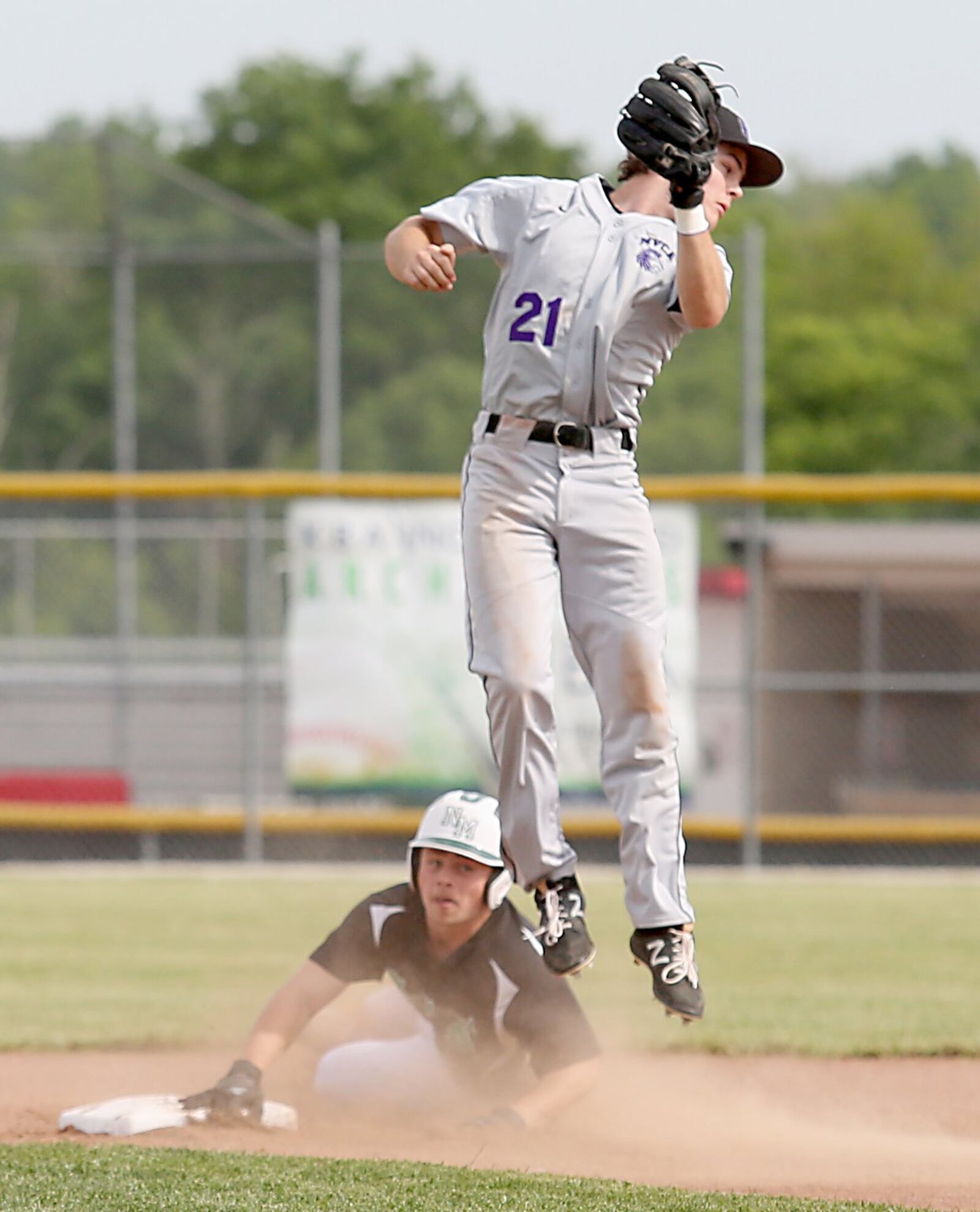 Miami Valley Christian Academy shortstop Sam Smith goes high for the throw as New Miami’s Christian Acus steals second base during Wednesday’s Division IV sectional final at Kings. CONTRIBUTED PHOTO BY E.L. HUBBARD