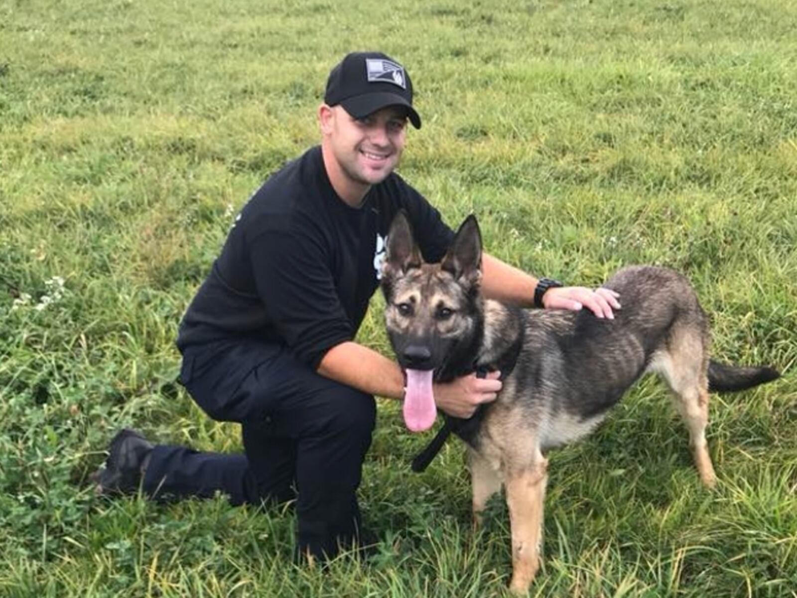 Robert Brinkman, a Liberty Twp. resident, was sentenced Wednesday after he pleaded guilty in October 2018 for importuning and contributing to the delinquency of a minor. Butler County Common Pleas Judge Greg Howard sentenced Brinkman to nine months in prison. Brinkman, a former Colerain Twp. police officer, is pictured here with his then-K-9 partner, Tao, on Oct. 5, 2017. COURTESY/COLERAIN TWP.